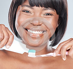 Happy black woman, portrait and toothbrush with toothpaste for dental care on a white studio background. Face of African