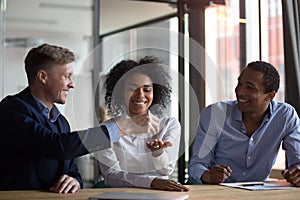 Happy black woman receiving keys from new home