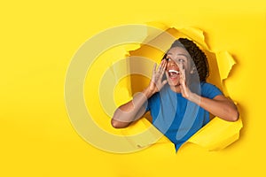 Happy Black Woman Shouting Posing In Torn Yellow Paper Background