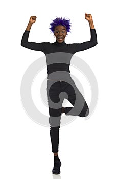 Happy Black Woman Is Standing On One Leg And Cheering