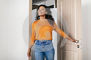 Happy Black Young Woman Entering Apartment Opening Entry Door