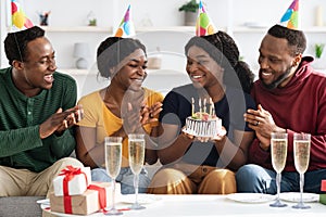 Happy black youngsters celebrating birthday at home