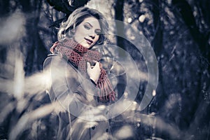 Happy blond fashion woman walking in autumn forest