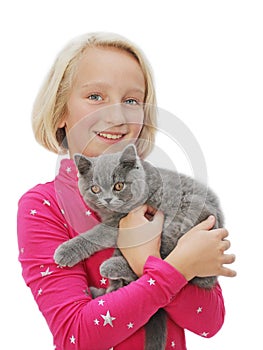 Happy blond girl holds a small fluffy kitten.