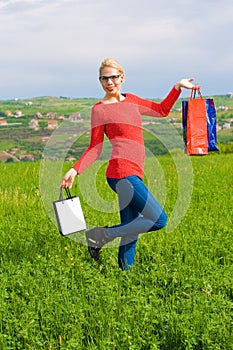 Happy blond Girl With Shopping Bags