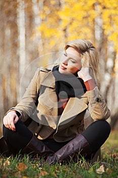 Happy blond woman in autumn forest