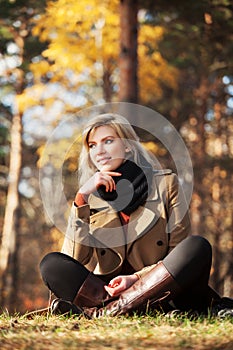 Happy blond fashion woman in autumn forest