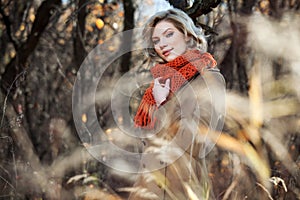 Happy blond fashion woman in autumn forest