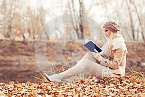 Happy blond woman in the autumn park