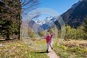 Happy blonde girl dancing and running in nature.