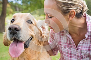 Happy blonde with her dog in the park