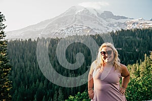 Happy blonde millennial woman poses at Mt Rainier National Park