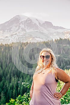 Happy blonde millennial woman poses at Mt Rainier National Park
