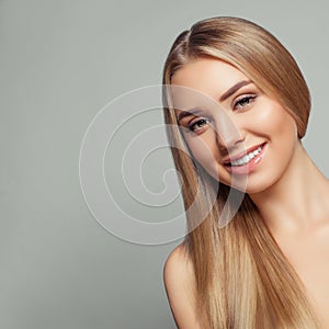 Happy blonde model woman with long healthy blonde hair