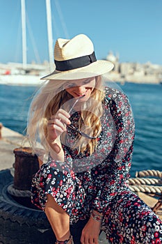 Happy blonde shy woman at Mediterranean sea