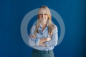 Happy blonde woman smiles broadly, dressed in casual clothing