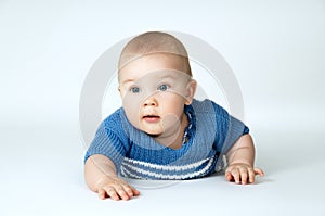 Happy blue-eyed baby boy closeup
