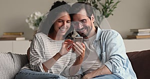 Happy bonding family couple using smartphone applications.