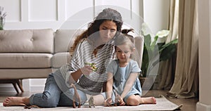 Happy bonding family of two playing with dinosaurs toys.