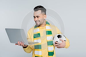 happy bookmaker with soccer ball looking
