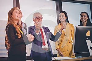 Happy Boss laughing with officer in multiculture office photo