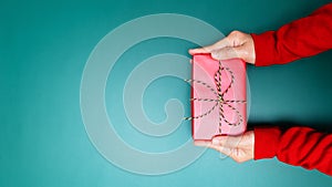 Happy Boxing Day, young woman hand with a gift box offer to receiver