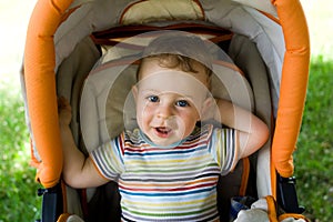 Happy boy in the baby carriage