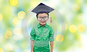 Happy boy in bachelor hat or mortarboard