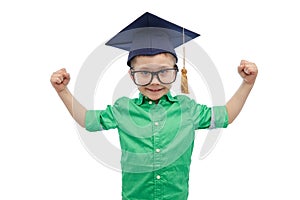 Happy boy in bachelor hat showing power