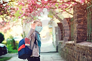 Happy boy with backpack going to school. Schoolboy wearing face mask outdoors. Education during coronavirus outbreak