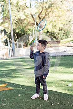 Happy Boy With Badminton Racket In Park.