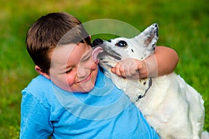 Happy boy being licked by his pet