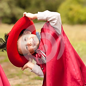 Happy boy in carnival costume musketeer