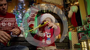 Happy boy child in Santa hat playing with airplane toy, father and kid playing