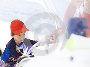 Happy boy driving a boat