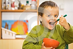 Happy boy eating - cereals