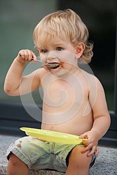 Happy boy eating chocolate cake