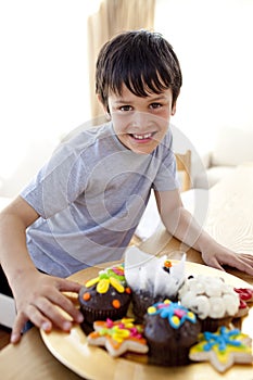 Happy boy eating colorful confectionery