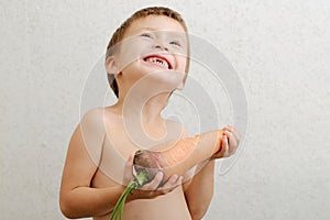 Happy boy edentulous with carrot