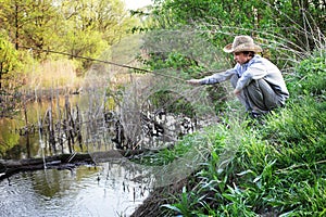 Happy boy fishing on the river