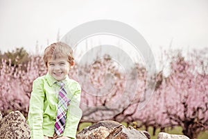 Happy boy by flowering trees