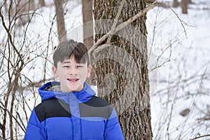 Happy Boy in Forest in Winter photo