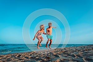 Happy boy and girl enjoy beach, kids play on sea vacation