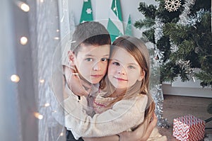 Happy boy and girl with his Christmas gift. Christmas, holiday and gifts.