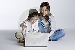 Happy boy and girl with laptop computer