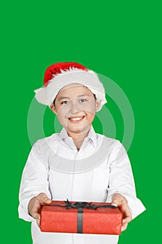 Happy boy gives Christmas gift in studio