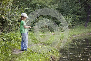 Happy boy go fishing on the river, one children fisherman with a