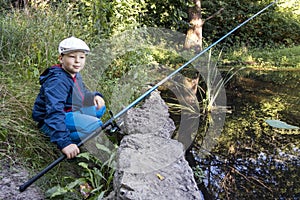 Happy boy go fishing on the river, one children fisherman with a