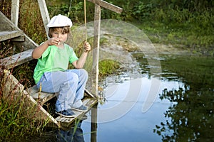 Happy boy go fishing on the river, one children fisherman with a