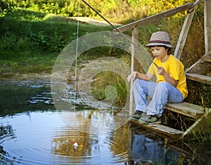 Happy boy go fishing on the river, one children fisherman with a